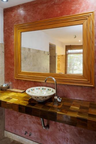 a bathroom with a sink with a large mirror at La Mision Mocona - Lodge de Selva in Saltos del Moconá