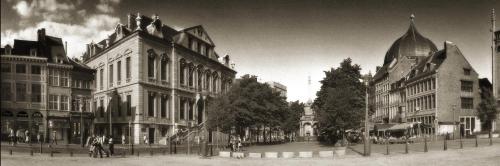 a black and white photo of a city street with buildings at Amosa Liège City Centre Hotel in Liège