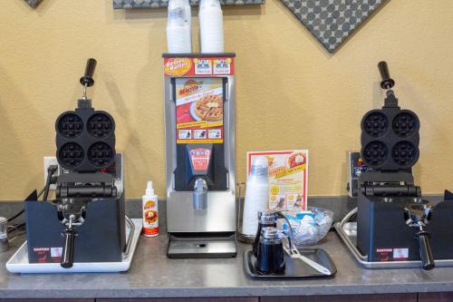 a counter with two coffee machines and a drink dispenser at Berlin Encore Hotel & Suites in Berlin