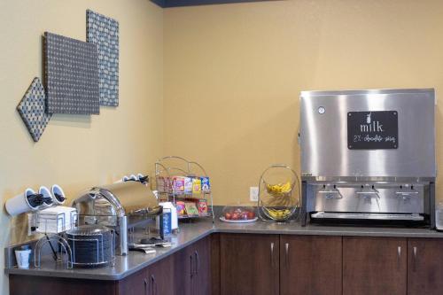 a kitchen counter with a coffee maker on top of it at Berlin Encore Hotel & Suites in Berlin