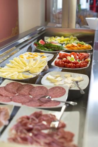 a buffet line with many different types of food at Hotel Villa Garuti in Padenghe sul Garda