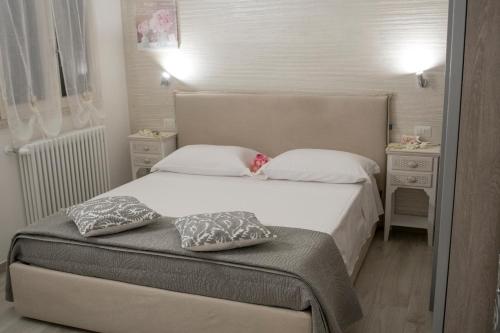a bedroom with a bed with two pillows on it at Casa fioRita in Vieste