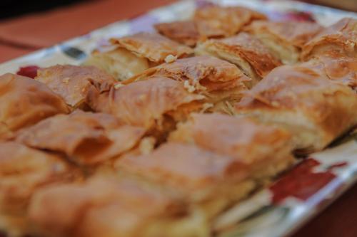 a close up of a pizza on a plate at Plaza Hotel in Loutraki