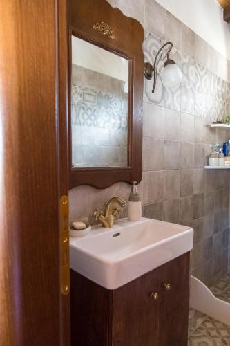 a bathroom with a sink and a mirror at Tasos House in Kalabaka
