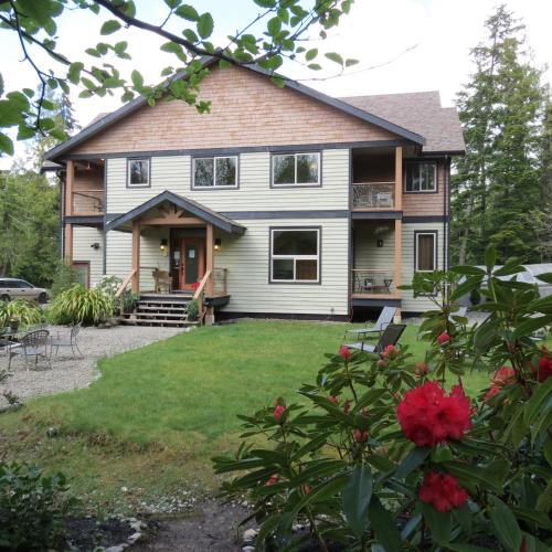 an exterior view of a house with a yard at Cobble Wood and Bird Sanctuary Guest Houses in Tofino