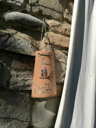 a bag hanging on the side of a stone wall at Prà de Mandè in Viano