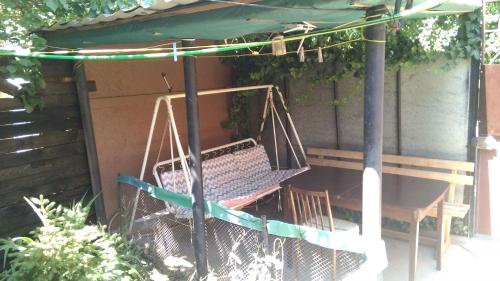 a swing in a backyard with a bench at Dom v Arkadii in Odesa
