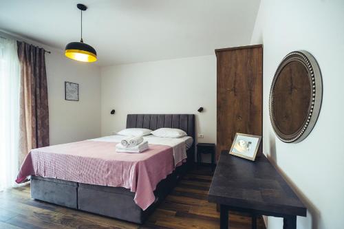 a bedroom with a bed with a pink blanket at Luxury Villa Borak in Imotski