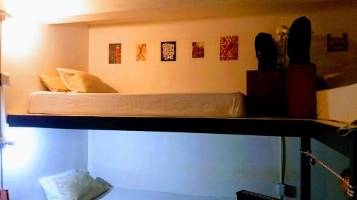 a bunk bed on top of a room at Casajungla Hostel in Jacó