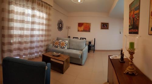 a living room with a couch and a table at AZAHARA 20 in Nerja