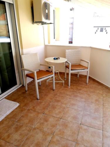 a dining room with a table and two chairs at Kalamata Downtown Apartment in Kalamata
