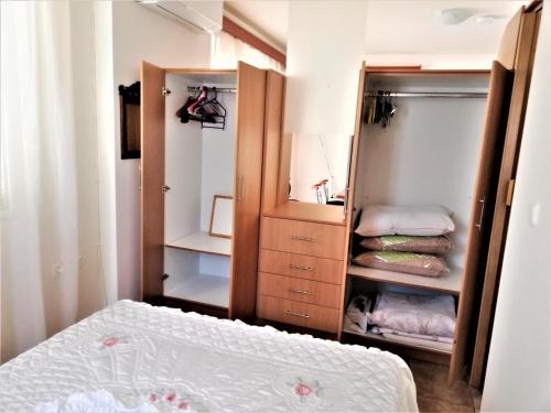 a bedroom with a bed and a cabinet with towels at Kalamata Downtown Apartment in Kalamata