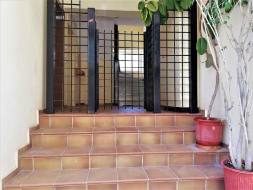 a gate on a set of stairs with plants at Kalamata Downtown Apartment in Kalamata
