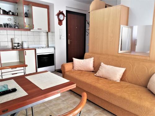 a living room with a couch and a table at Kalamata Downtown Apartment in Kalamata