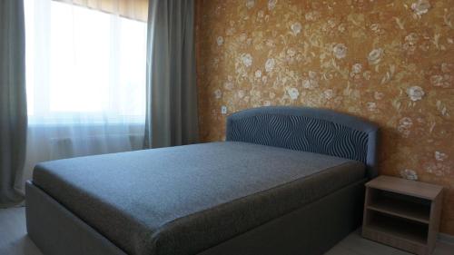 a bed in a room with a window and a bed sidx sidx sidx at Sunny Ventspils 9 in Ventspils