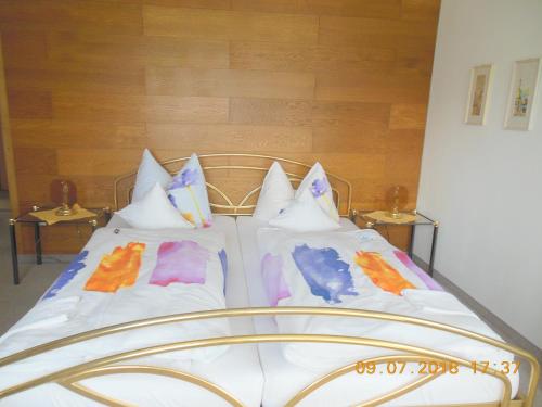a bed with white sheets and pillows on it at Ferienwohnungen Josef & Karin Ketterl in Sachrang