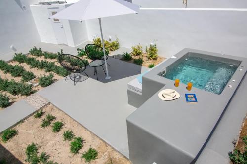 an overhead view of a swimming pool in a house at Apanomeria Boutique Residence in Oia