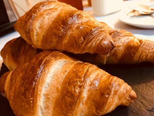 a pile of croissants sitting on top of a table at The New Court Inn in Usk