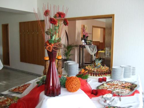 a table topped with plates and bowls of food at Hotel Rose in Georgsmarienhütte