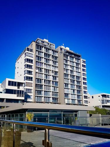 a large apartment building with balconies in front of it at Heaven on Earth - Blouberg Beachfront Self-catering Apartment in Bloubergstrand