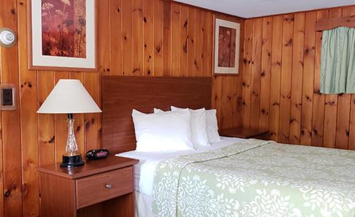 A bed or beds in a room at Gorham Motor Inn