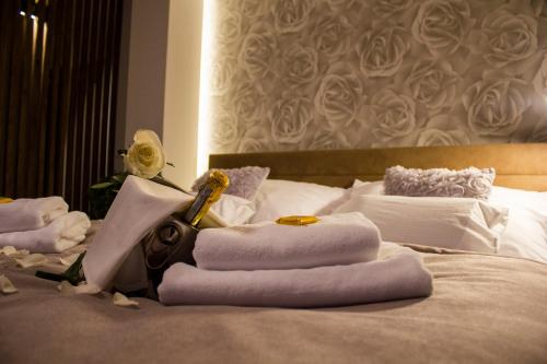 a pile of towels sitting on top of a bed at Penzion ZENIT in Prešov
