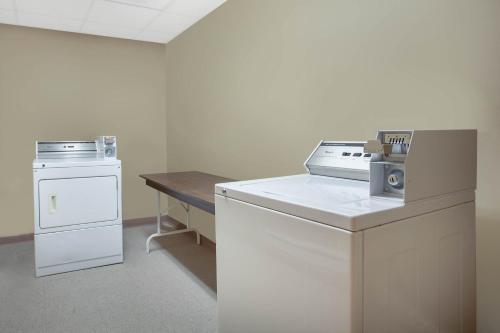 a kitchen with a stove and a dishwasher at Super 8 by Wyndham Midland in Midland