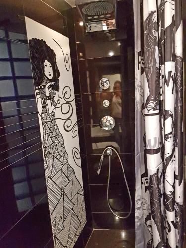a bathroom with a drawing of a woman in a shower at Słoneczny in Kielce