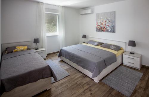 a bedroom with two beds and a window at Villa vista sul Quarnero in Matulji