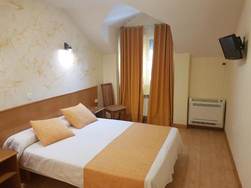 מיטה או מיטות בחדר ב-Hotel Camargo
