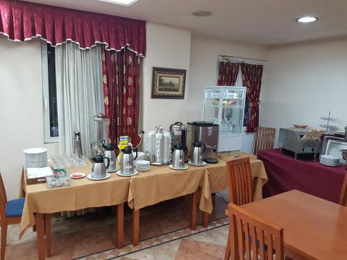a dining room with a table with a tableablish at Hotel Camargo in Igollo