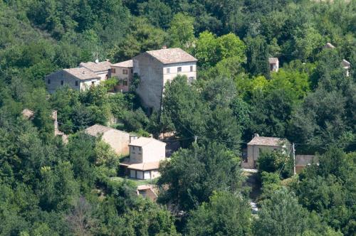a group of houses on a hill with trees at B&B La Cappellania in Montegiorgio