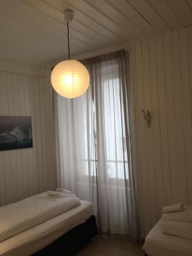 a bedroom with a window and a chandelier at Appartement Alexandra in Chamonix-Mont-Blanc