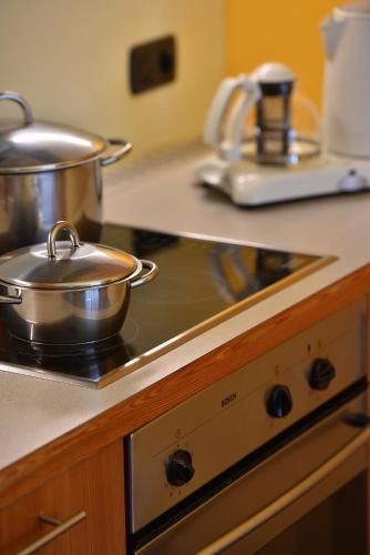 two pots and pans on a stove in a kitchen at Chalet Matteo in Livigno