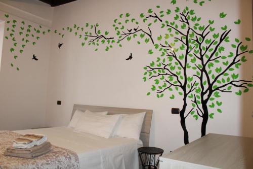冈多菲堡La Casetta Superior的卧室墙上有树和鸟