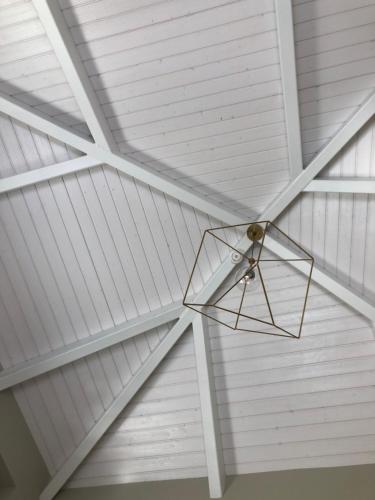a star hanging from the ceiling of a white ceiling at A Casa dos Nores Charming House in Cangas de Morrazo