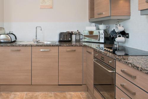 a kitchen with a sink and a counter top at Riverview Apartment in Durham