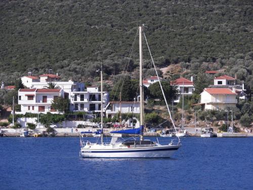 a sailboat in the water in front of a city at Blue Dreams in Almiropótamos