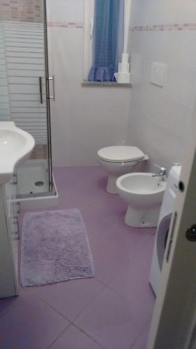 a bathroom with a toilet and a sink and a shower at lake house in Mezzanego