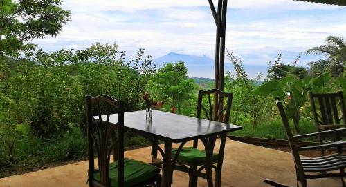 a table and chairs with a view of a mountain at Tierra Madre Eco Lodge in Los Andes