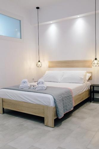 a bedroom with a bed with two towels on it at Calmio Apartments - Kavala in Kavála