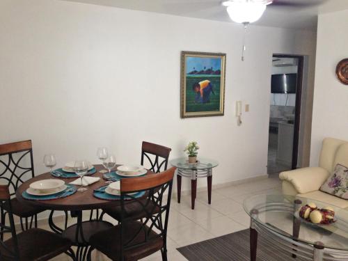 uma sala de jantar e sala de estar com mesa e cadeiras em Caribbean Seaview apart Malecon Santo Domingo em Santo Domingo