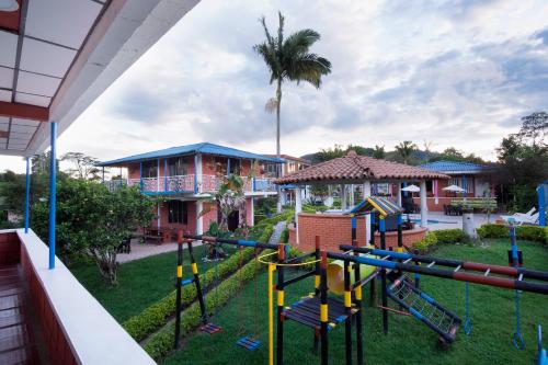 a playground in front of a house at Finca Campestre Villa del Campo in Santa Rosa de Cabal