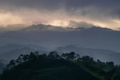 a view of a mountain range with clouds and trees at Finca Campestre Villa del Campo in Santa Rosa de Cabal