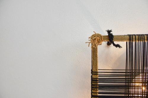 a bird sitting on top of a wall at Angelos Boutique Suites in Patitiri