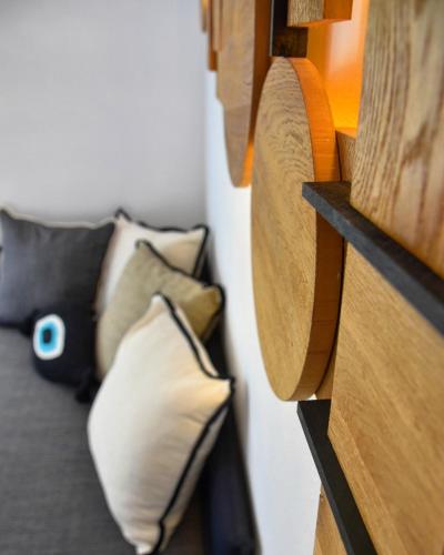 a bedroom with a bed with pillows on it at Angelos Boutique Suites in Patitiri