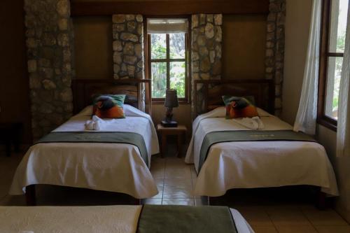 a bedroom with two beds in a room at Hotel Bahia Taitza in Flores