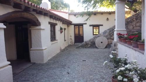 a courtyard of a house with a stone walkway at El Molino de Cachi in Cachí