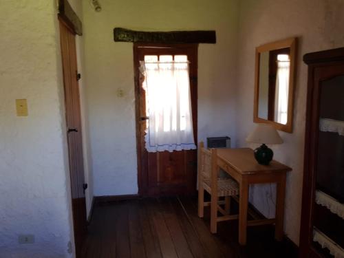 a room with a desk and a window and a door at El Molino de Cachi in Cachí