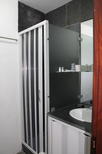a bathroom with a sink and a mirror at Casa da Muralha Suíte in Monsaraz